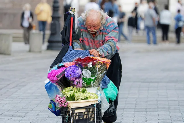 man, elderly, flower seller, florist, pushing, flower cart, pavement, street, urban, old town, tourism, lifestyle, vintage. 5 points on florist inventory and sourcing that matter