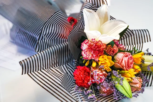 flower bouquet, lilies, carnations, roses, freesia, colorful flowers, striped wrapping, elegant bouquet, gift flowers, celebration bouquet, fresh flowers, floral arrangement, romantic flowers, flower composition, blooming flowers, florist art, spring bouquet, flower detail, wedding flowers, mixed flowers, beautiful bouquet, love and beauty, floral texture, flower gift, nature elegance. Florist Startup Costs, Pricing and Operations