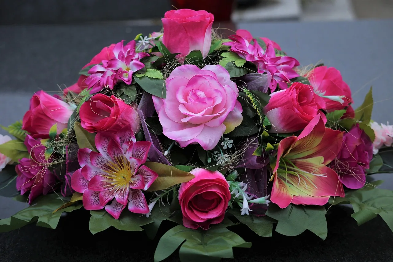 colorful artificial flowers, roses arrangement, decoration, condolence, black marble, gravestone, cemetery, outdoor, condolence, gravestone, gravestone, gravestone, gravestone, gravestone, cemetery, cemetery, cemetery, cemetery, cemetery. Sympathy Flower Arrangement Pricing: What to Charge and Why